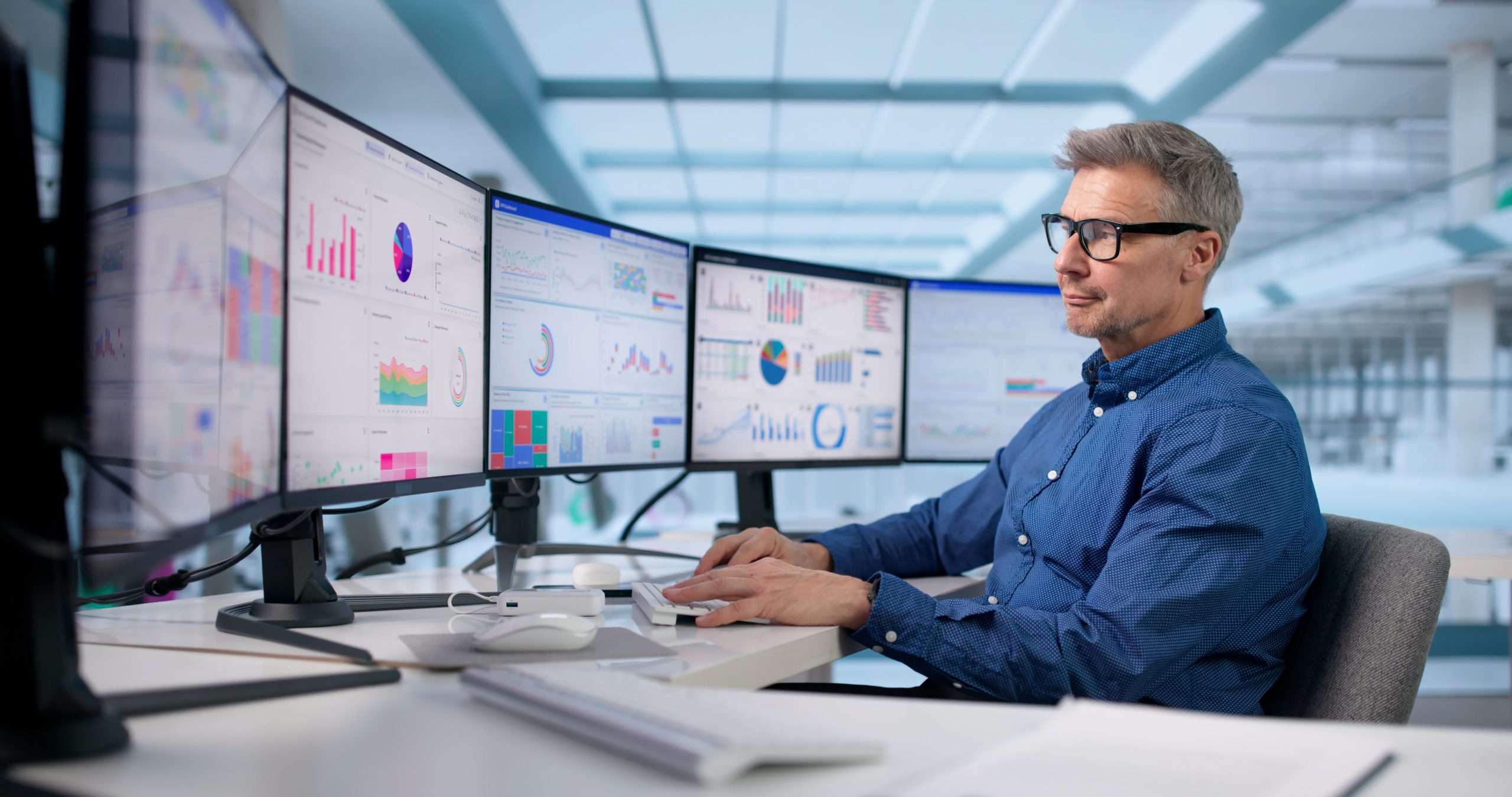 Focused Businessman Analyzing KPI Data On Office Computer Dashboard