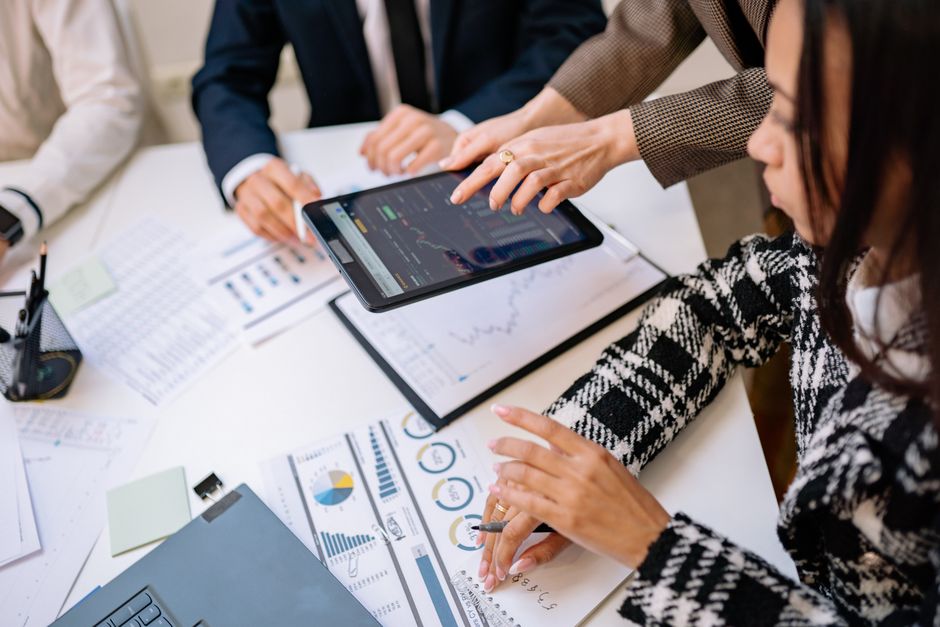 People reviewing charts and graphs at table