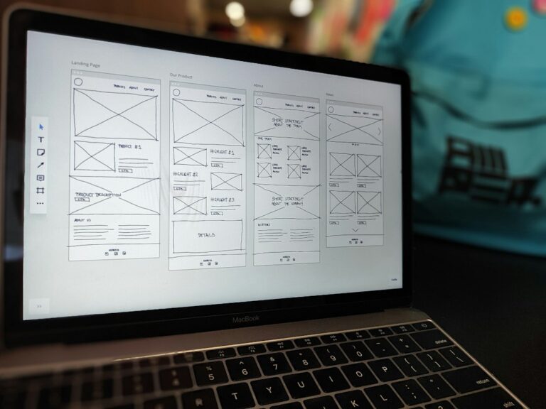 Laptop showing mobile app wireframe sketches
