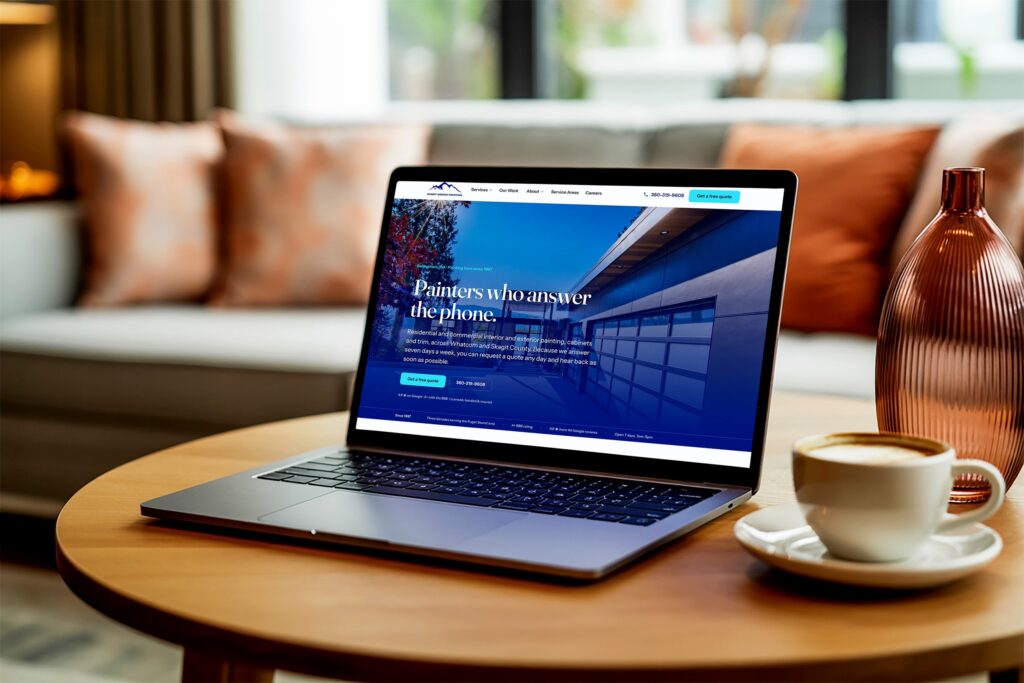 Puget Sound Painting website on a laptop: painters who answer the phone, across Whatcom and Skagit County